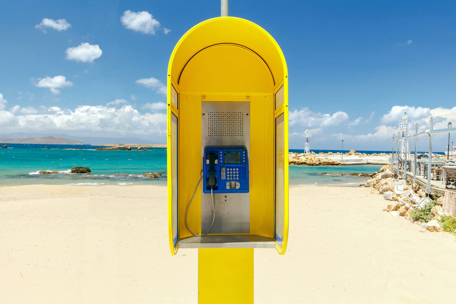 Scenic beach contact us banner featuring a phone booth – reach out to AQTIVAQUA for exceptional swim gear and support