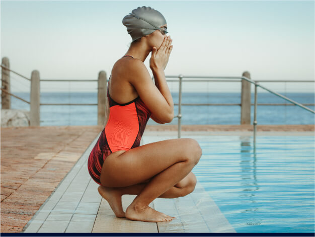 Woman preparing to enter the pool – get ready for your swim session with AQTIVAQUA's premium swim gear designed for optimal comfort, protection, and performance in the water